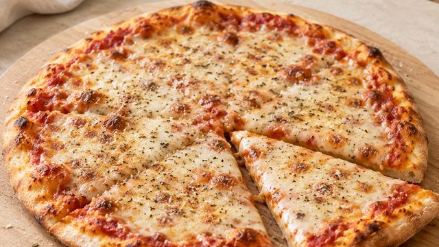 A thin, cheesy pizza on a wooden board.